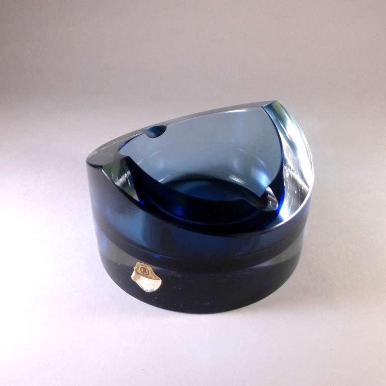 Circular Murano glass ashtray designed by Seguso with a cobalt centre cased in clear glass.