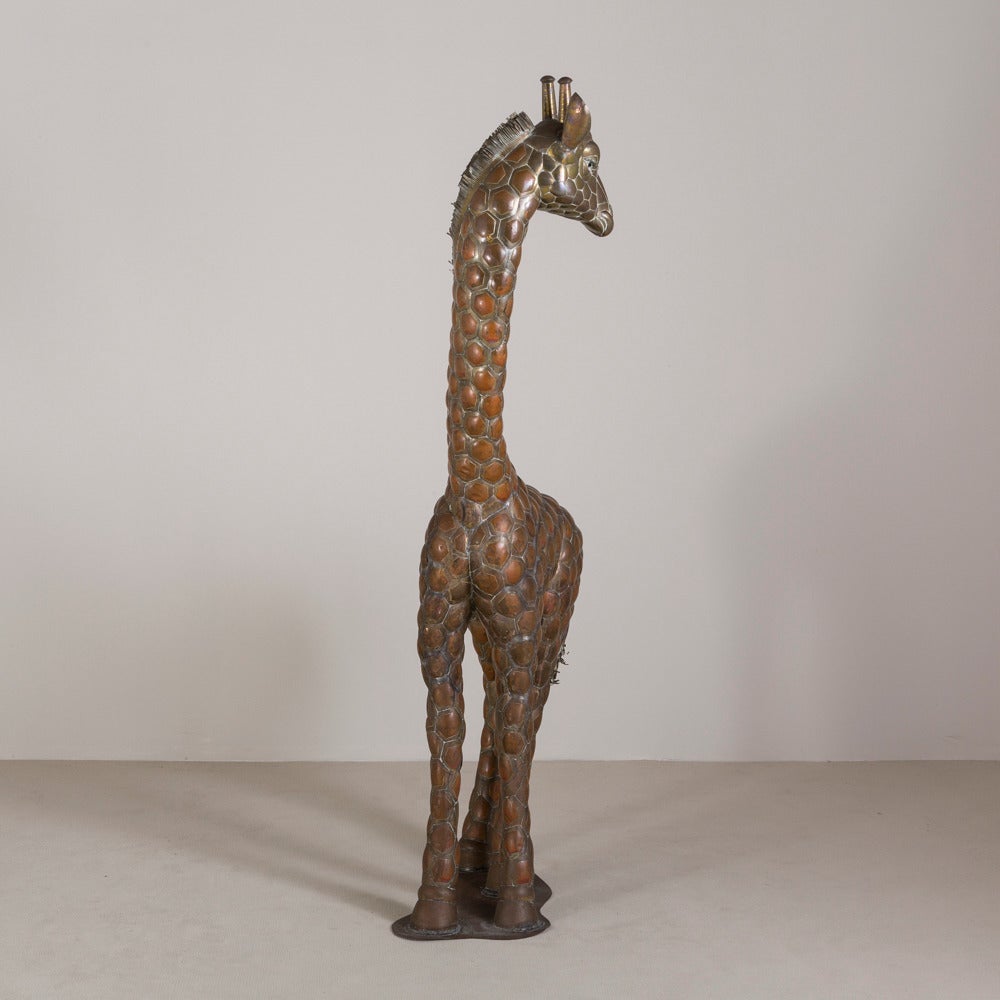 A copper and brass giraffe by Sergio Bustamante 12/100 plaque

Sergio Bustamante is a Mexican Artist and sculptor. He began with paintings and papier mache figures, inaugurating the first exhibit of his works at the Galeria Misracha in Mexico City
