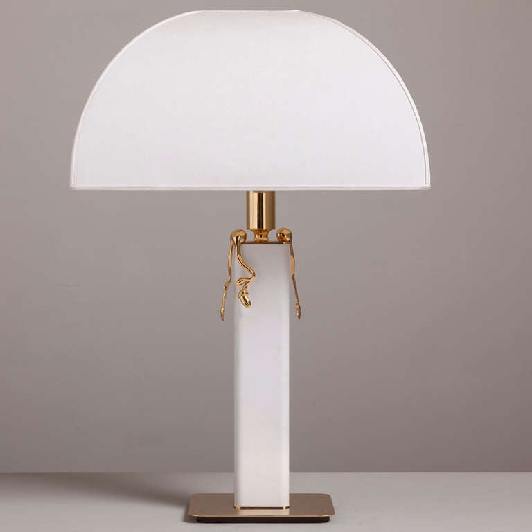 A 1980s white leather wrapped and brass-plated table lamp with original shade.
