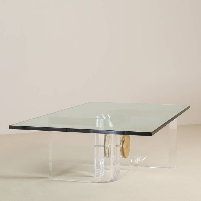 Heavy Lucite 's' shaped coffee table base with chunky brass bolt structural detail, circa 1970s. Without glass top.

Base only 70cm x 58cm x 36.5cm high. 
Photographed with glass measuring 140cm x 76cm
Glass can be supplied at cost.