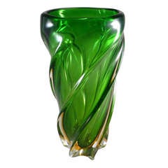 A Vibrant Green Twisted Glass Vase with Amber Base