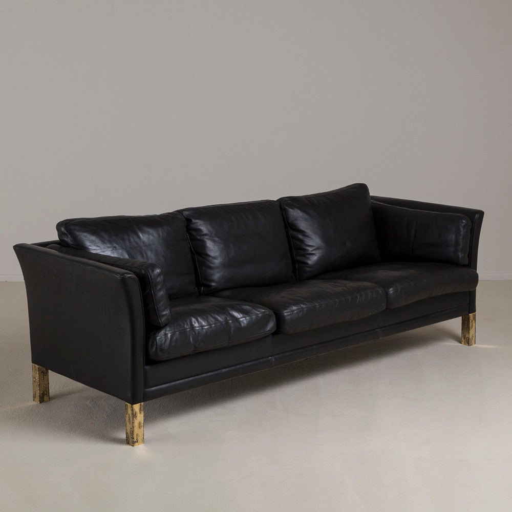 A Danish Mogens Hansen designed black leather upholstered sofa with sculpted brass legs 1950s, our edition. 

These signature Børge Mogensen designed Danish leather sofas are part of an expanding ‘Danish Collection’ that Talisman is building, often