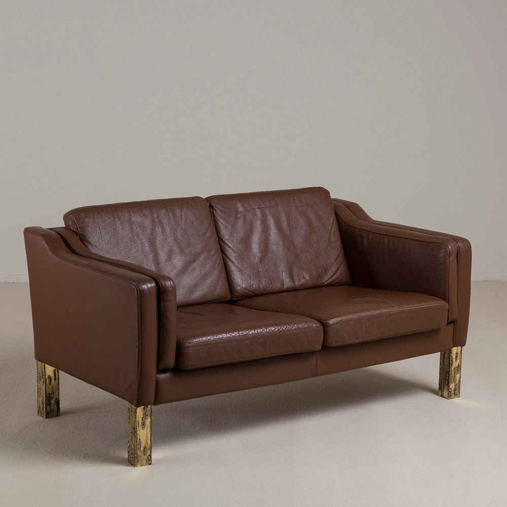 A Danish Borge Mogensen attributed Brown Leather Upholstered Two Seater Sofa with Sculpted Brass Legs and Unusual Double Arm Cushion 1960s, Talisman Edition