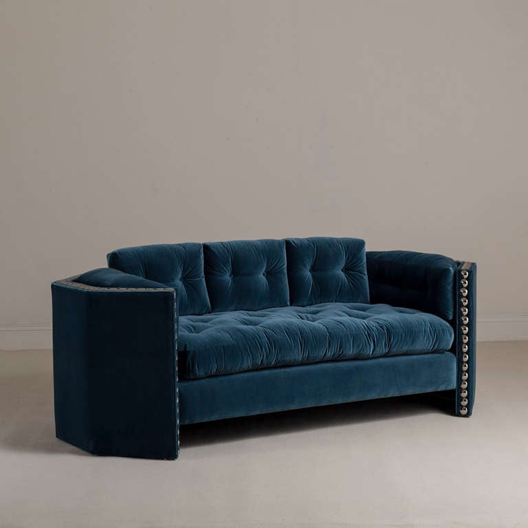 An Octagonal Framed Studded Teal Cotton Velvet Upholstered Sofa by Talisman Bespoke. 

This statement sofa is inspired by a unique American 1970s design and is part of a collection that is available to order in any fabric and can be adapted to a