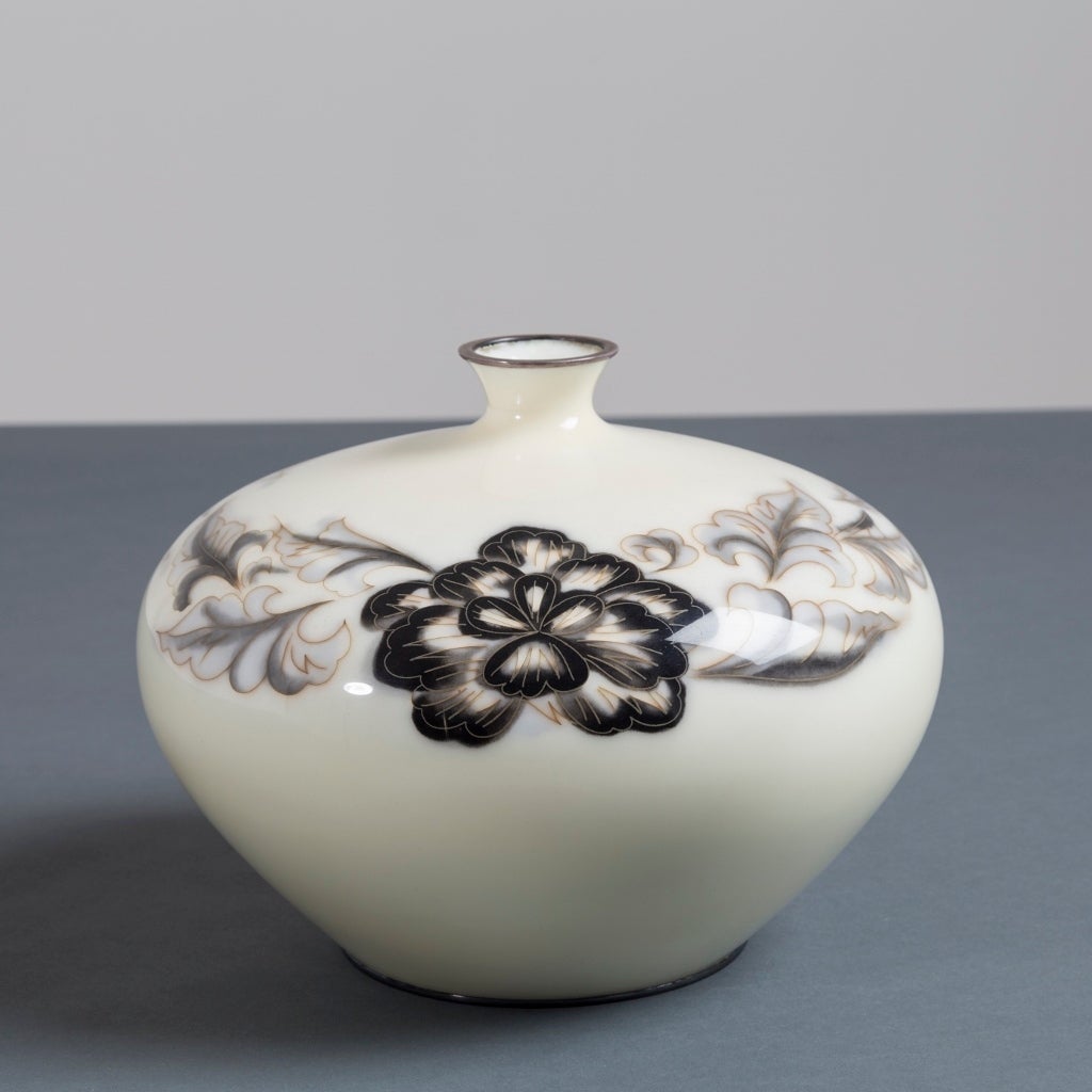 A Japanese cloisonné cream enamel vase depicting black flowers by Ando, circa 1930

