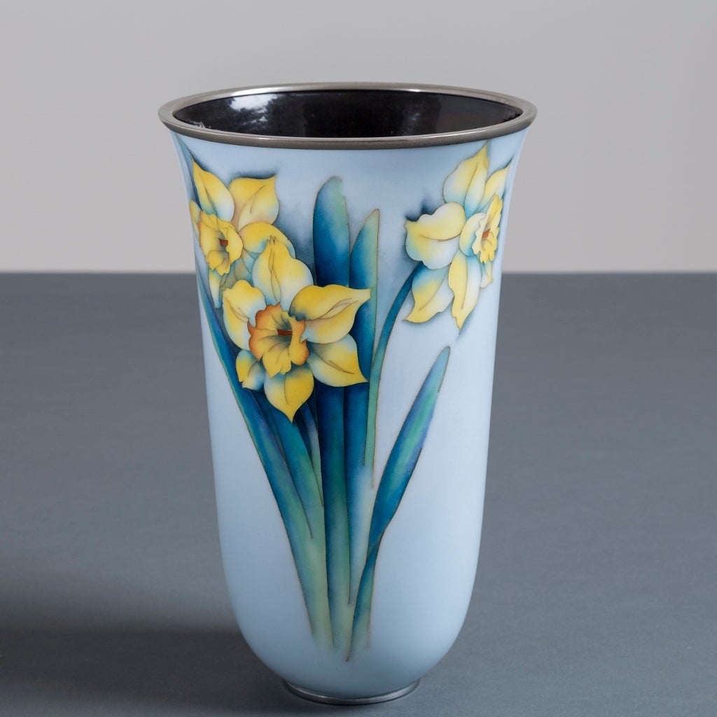 A light blue Japanese cloisonne enamel vase with a stand of daffodils, stamped Ando, Showa period, 20th century
