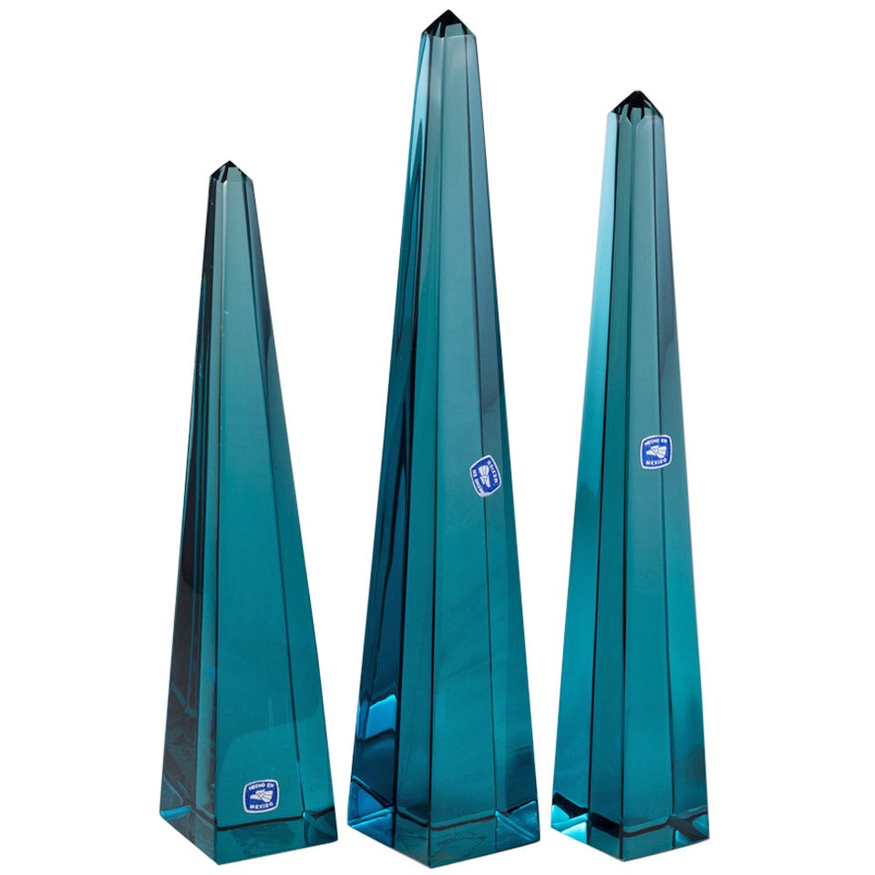 A Set of Three Teal Blue Glass Obelisks