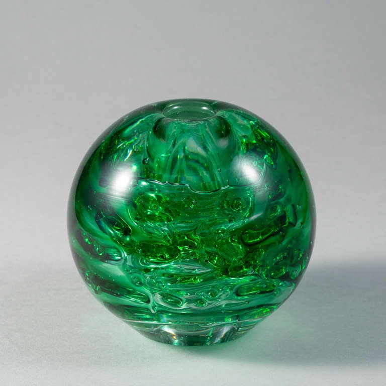 A green round glass candleholder.