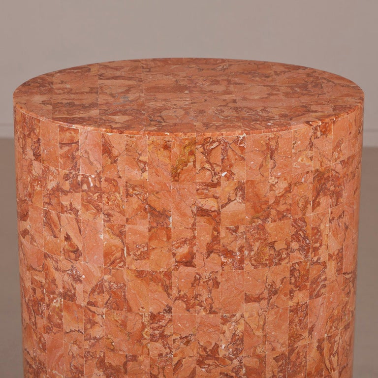An oval stone veneered pedestal attributed to Maitland-Smith, 1980s.
Footprint measures 45cm wide x 35cm deep.

Maitland Smith was established in 1979. They used highly skilled artisans and quality raw materials to create decorative accessories and