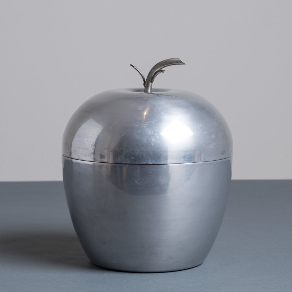 A lidded apple shaped ice bucket in brushed aluminium with an inner lining
