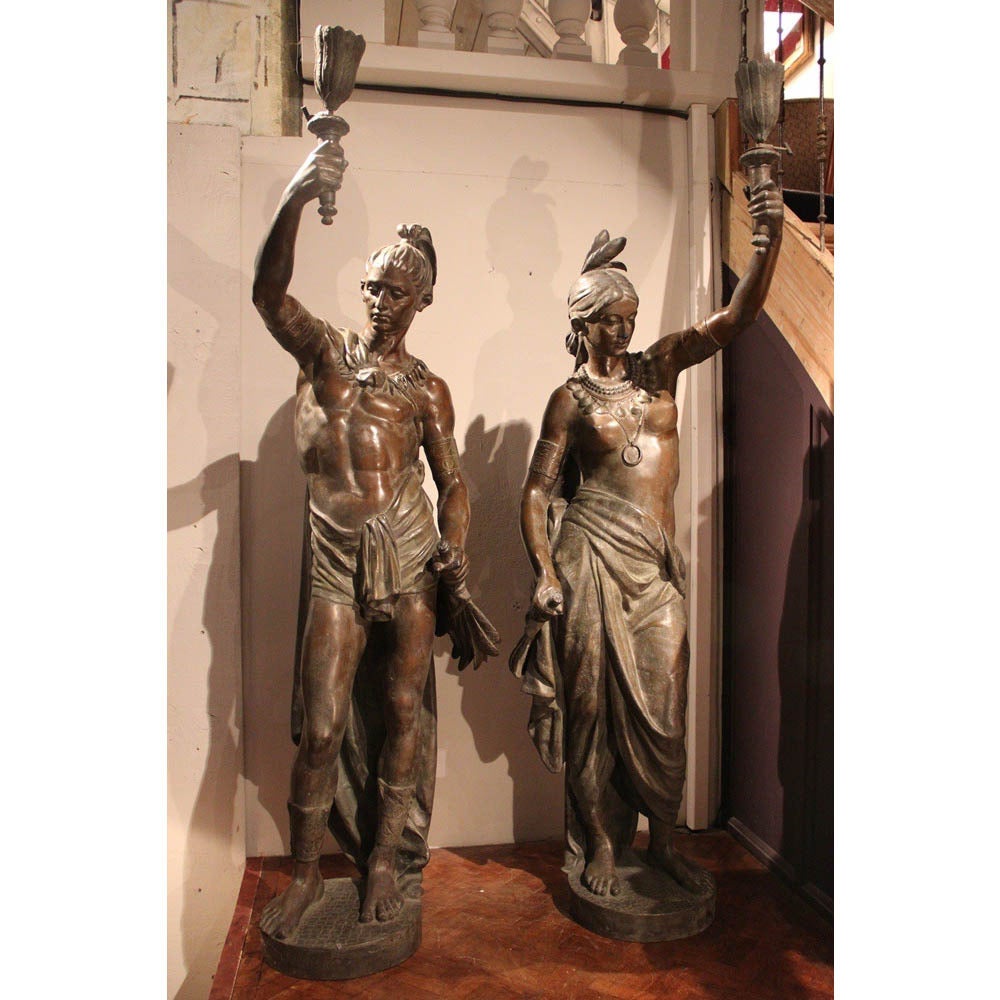 A pair of late 20th century bronze North American Indian torchères cast from the original 19th century, Parisian models. 

These were originally cast by the French foundry Ducell of Paris, circa 1880. This present pair were cast in England by
