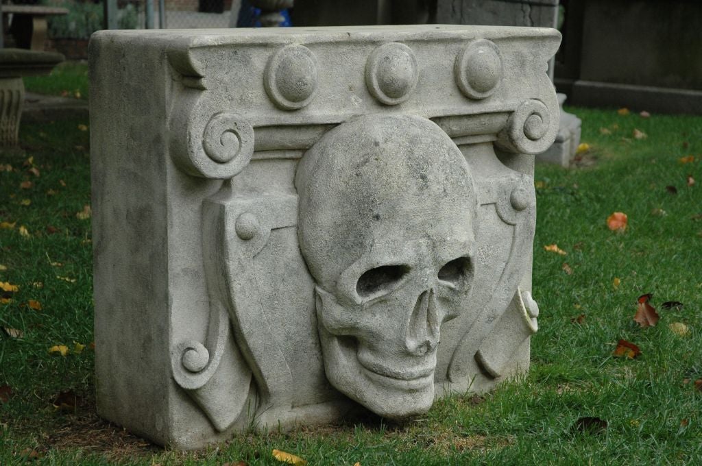 Italian, 20th Century, hand carved remarkably unique limestone skull. It depicts a heraldic plaque with a high relief skull. One pair available, priced and sold individually. The pair would make a perfect dining table or work individual as end