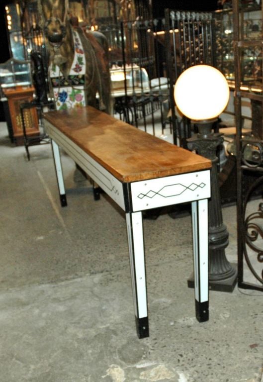 American, circa 1920's enamel table with classic hardwood tabletop used extensively in butcher shops with complete enamel interior.  Excellent aged pantination on wood.  Nice black and white detailing of the enamel on the sides and legs, beautiful