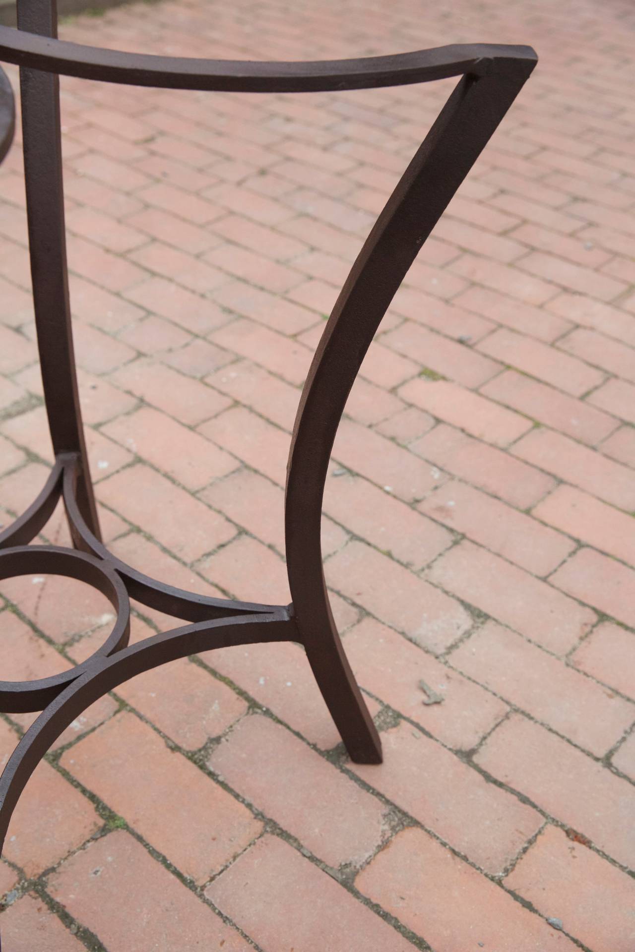 BF.15
A re-creation wrought iron dining table base of simple design with four legs and curved top, appropriate for stone or glass as well as indoor or out door use.In oxidized brown or black waxed finish.
Height: 28  Width: 21  Length: 21