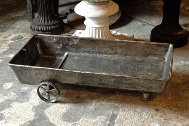 American, cast iron cart, industrially used as a giant oil drain pan for farm equipment c. 1870.   Excellent as a coffee table with a glass top or as a unique artifact of the industrial age.
