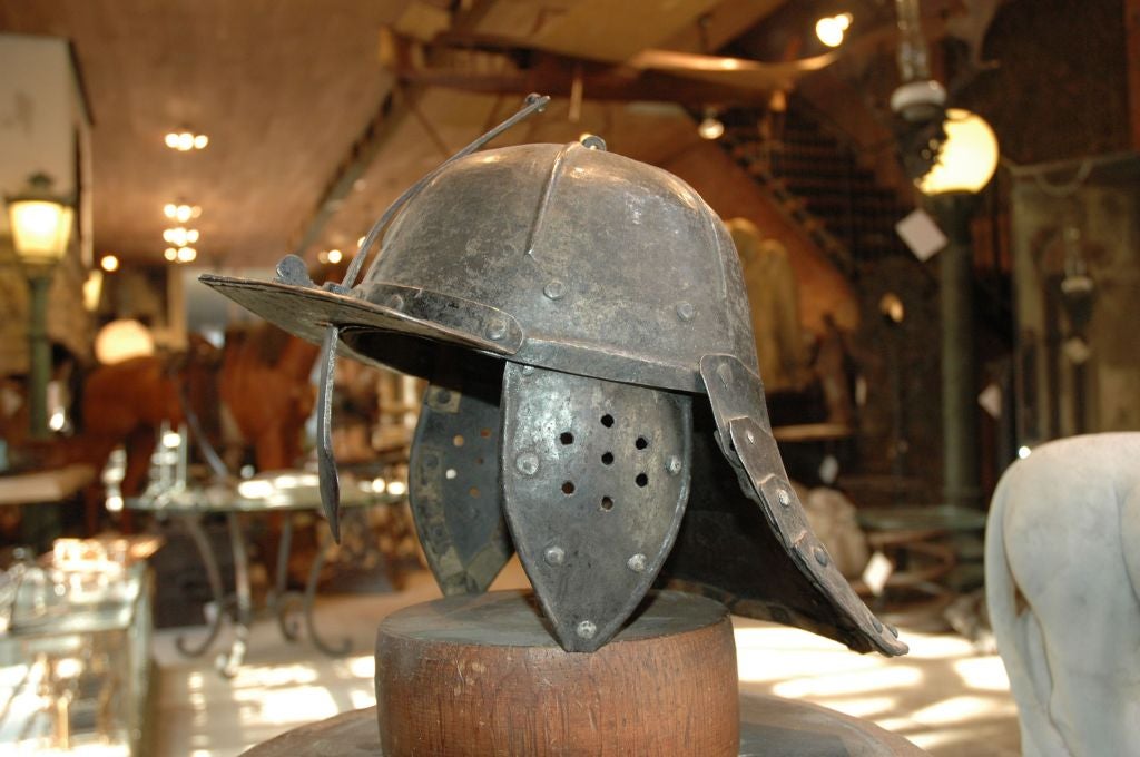 English, circa 1640's Roundhead's helmet. Made of mill rolled steel and riveted construction, it has a 'lobster tail' articulated neck guard, and adjustable nasal guard secured with a heart shaped wing nut. This helmet was used by The New Model Army