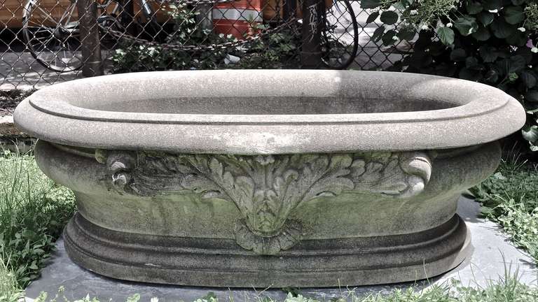Hand carved Italian 20th century limestone basin of great scale with floral carving on both sides. Great as a garden ornament or jardiniere. Two available. Priced Individually.