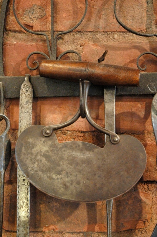 American, early 19th century collection of unique cooking utensils with beautifully made hand forged iron stand. Eleven tools are included with the stand, each item is unique and hand made. Sold only as a set. The overall dimensions as shown is 31