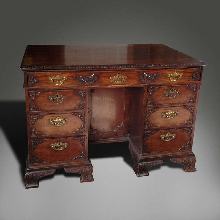 Irish Small Mahogany Desk With Carved Detail And Brass Handles For Sale
