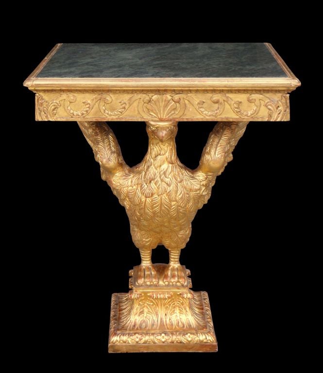 A Very Finely Carved and Gilded Marble Topped Console Table after a Design (circa 1730) by William Kent.<br />
<br />
The inset jade green marble top above a Vitruvian Scroll frieze is supported by a perched eagle on an acanthus and egg and dart