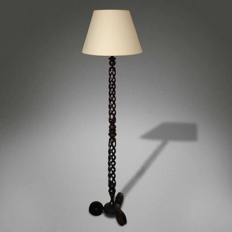 A Spiral Column Ebony Standard Lamp

Upon a circular base with three round feet 

Anglo Indian, 20th century