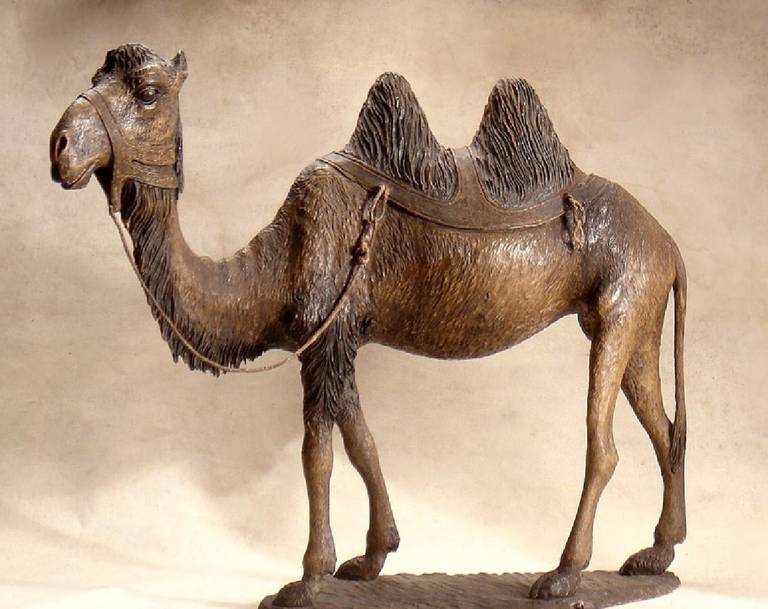 A Continental Stained and Polychrome Decorated Wood Model of A Camel
Early 20th Century
