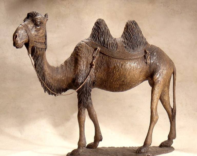 A Continental Stained and Polychrome Decorated Wood Model of A Camel