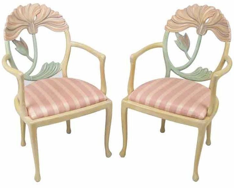 An inspired rendition of a traditional form, these Italian made armchairs have large floral carvings of poppies within oval backs, slightly cabriole legs and striped pink silk upholstered seats. Purchased with a Phyllis Morris bed and dresser from
