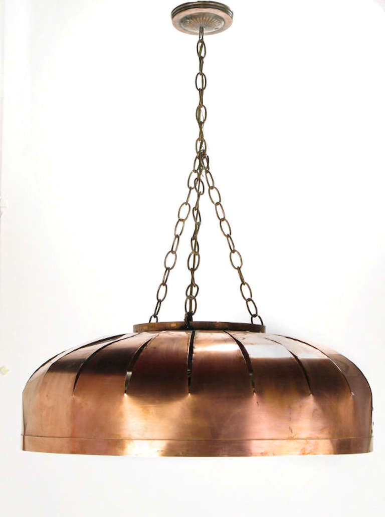 Large copper shade hanging light fixture with concentric circle diffusers. Copper chain and canopy, four incandescent light sockets.