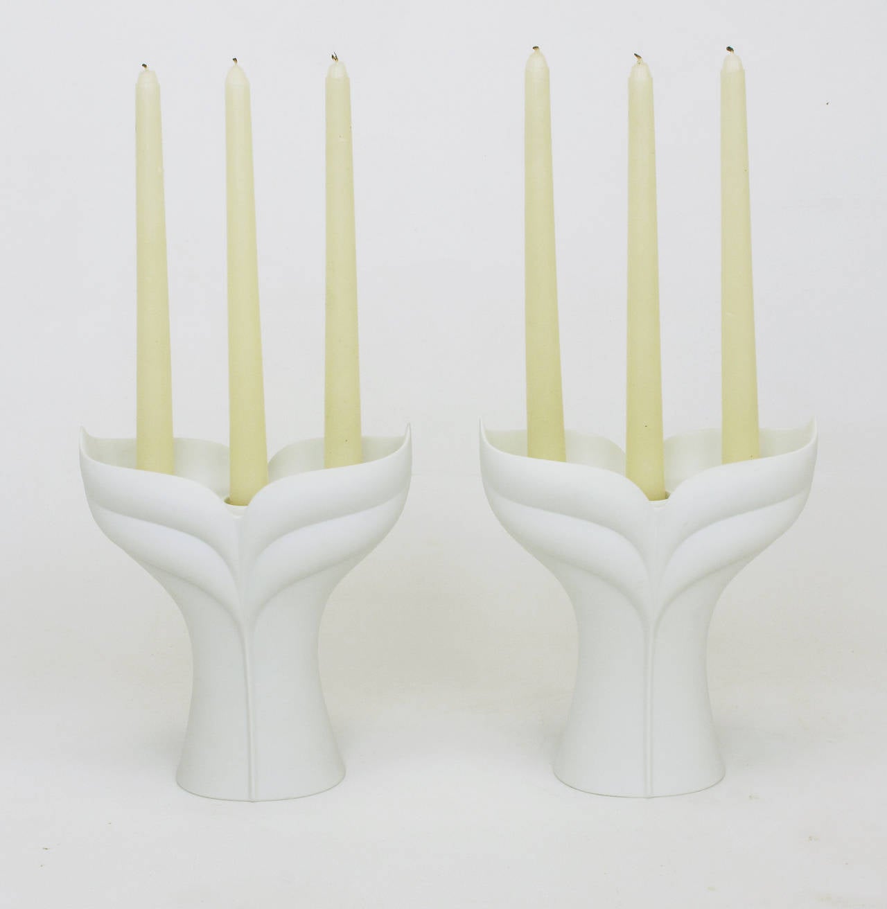 Pair of white matte porcelain three-light candelabrum by Uta Feyl for Rosenthal Studio Linie. Sometimes referred to as Feyl's Lotus line for Rosenthal, Germany.
Introduced in 1982 and no longer in production.
