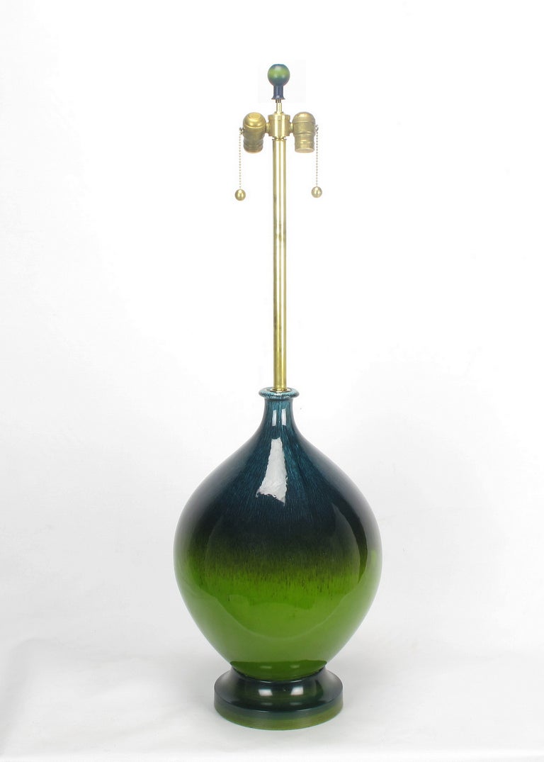 Impressive and well proportioned hand thrown ceramic table lamps. Normal and slight color variance in the the blue portion of the gourd form bodies, consistent with handcraft.  Predominant colors are emerald green and cadet blue with heathered and