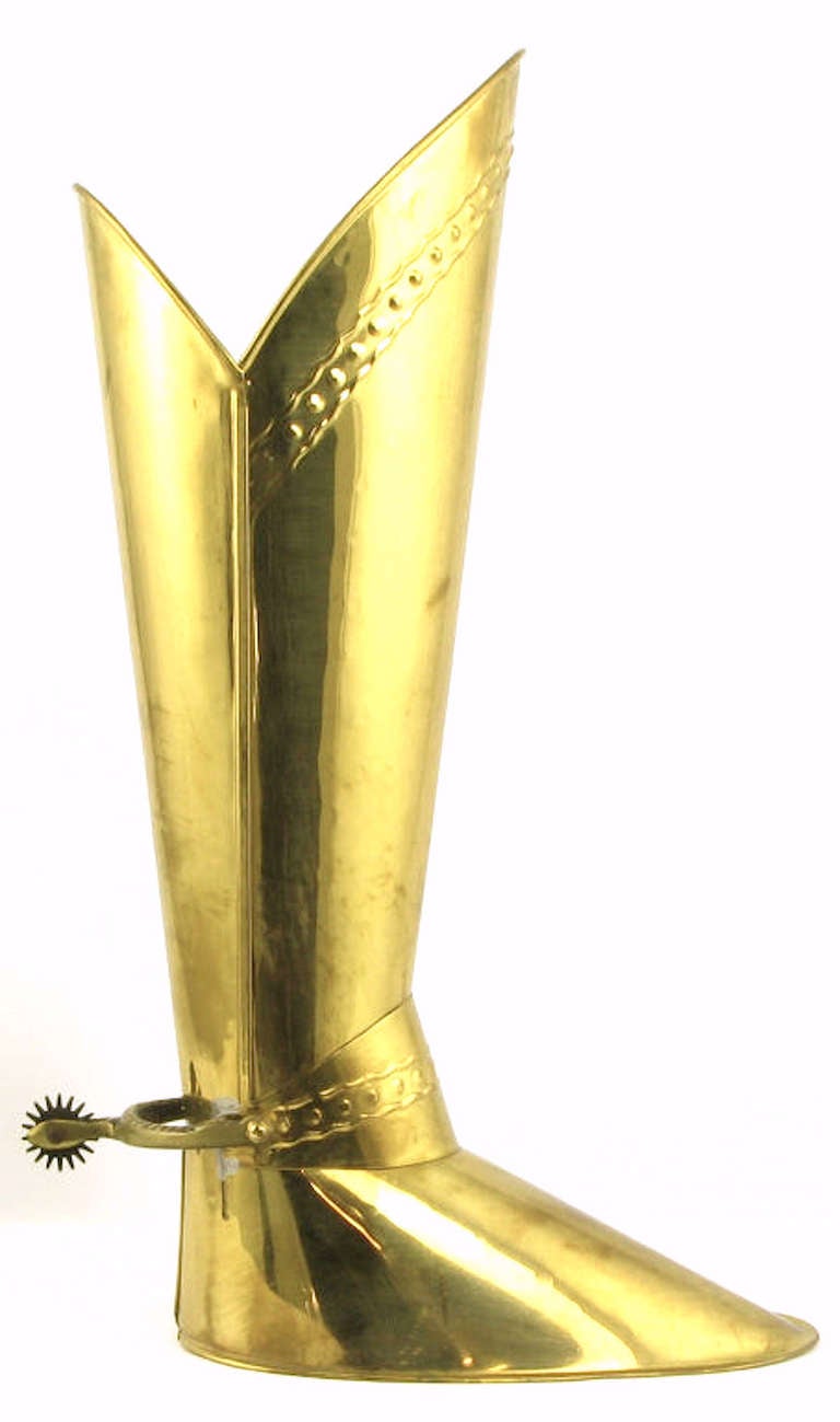 Brass umbrella holder in the form of a riding boot, with stamped brass detail and solid brass spur. Heavily weighted for stability. Stamped 