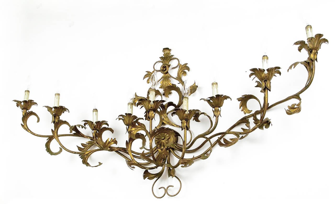 A fine Italian gilt metal single sconce with nine lights and wonderful Rococo ornamentation. Measures: 54