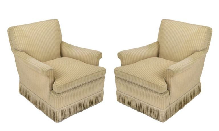 Pair of taupe cut wool stripe rolled arm club chairs in the style of vintage Kittinger of Buffalo, NY. Corded silk fringe skirt can used as is or removed. The legs are dark stained tapered walnut.
Extremely comfortable with exaggerated rake to the