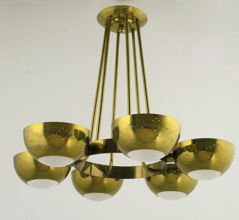 Gerald Thurston for Lightolier six light chandelier with bent brass rods, brass ring and pierced brass cups with convex frosted glass inserts. 360 watts of illumination.