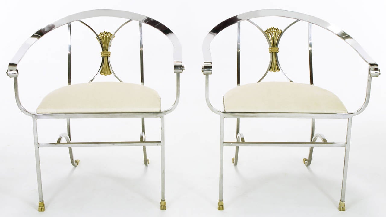 Beautifully crafted pair of polished wrought iron side chairs with brass acanthus leaf feet and a brass wrapped sheath appointment on the back. Newly upholstered seats in natural linen.