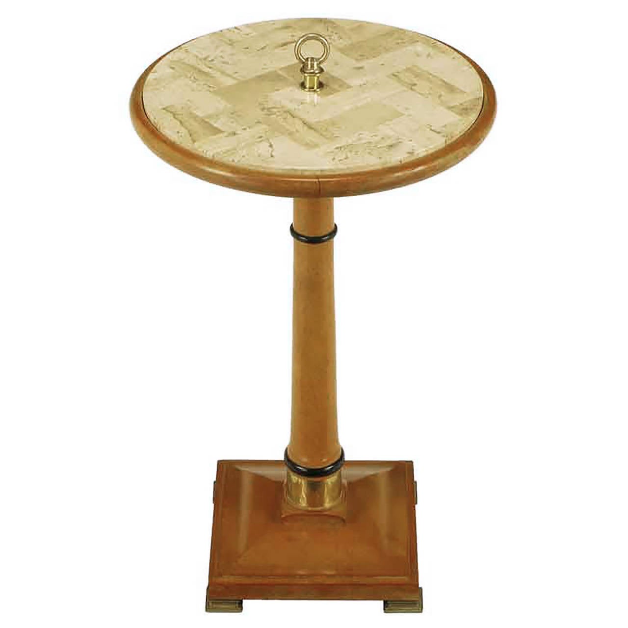 Bleached mahogany tessellated herringbone travertine Gueridon with centre ring. Pedestal column with black lacquer rings and lower brass cuff support round top. Square beveled base with brass feet.