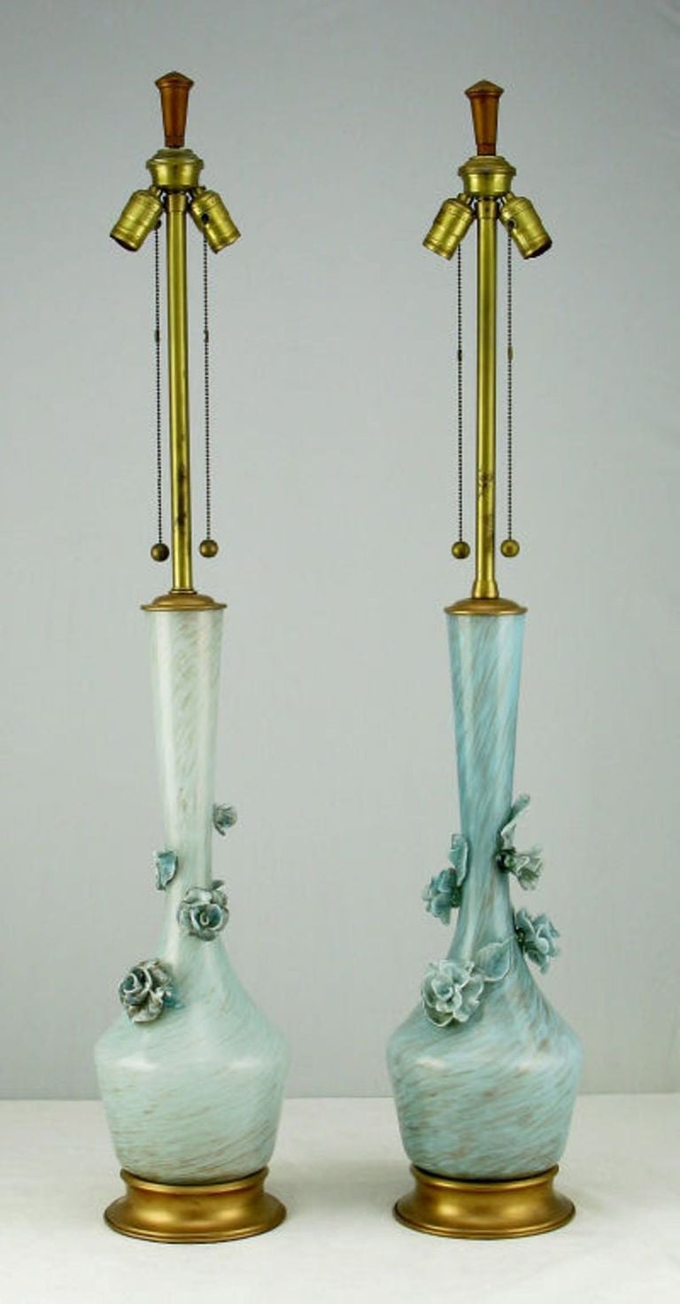 Pair of large blue hand blown Marbro Murano glass table lamps with gold leafed brass caps and bases. Each lamp adorned with blue glass flowers and leaves, and the normal color variation of hand blown glass. Each lamp has the signature Marbro double