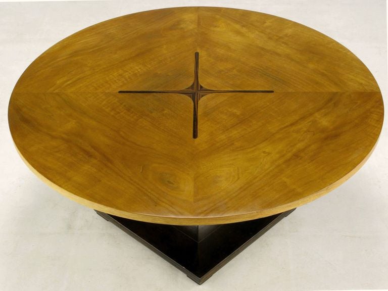 Beautifully grained figured teak with an X-form rosewood inlay and a dark walnut square pedestal base combine to form this elegant and understated round coffee table.
