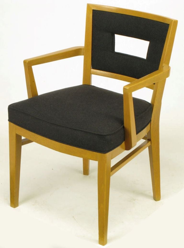 Set of eight white oak clean lined dining chairs with new black flannel upholstery. Manufacturer is undetermined, but build quality is on par with Edward Wormley for Dunbar or T.H. Robsjohn-Gibbings for Widdicomb. Thick padded and sprung set