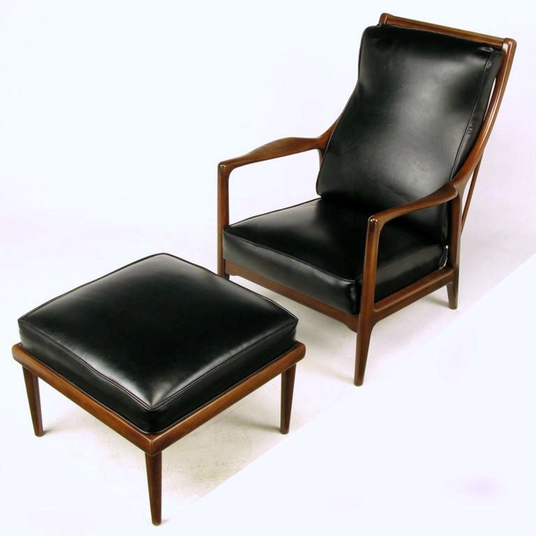 Early Milo Baughman reclining lounge chair and matching ottoman. Finely crafted walnut frame and quality heavy black vinyl covering to the removable back cushion, fixed seat cushion and fixed ottoman cushion. Possibly a James Inc. or Glenn of