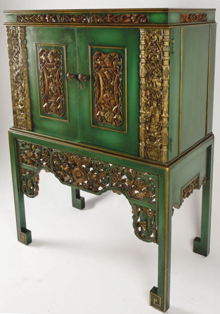 According to the original owner's family, this cabinet was constructed in the 1950s. 19th century carved gilt panels were incorporated into the design, a la James Mont.