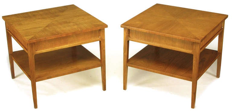 Clean lined parquetry top square side tables by Michael Taylor for Baker's New World Collection. Understated four sided detailing with recessed apron panels and a single fixed shelf. Base recessed under the beautifully grained four piece parquetry