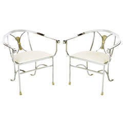 Pair of Polished Iron and Brass Scroll Armchairs