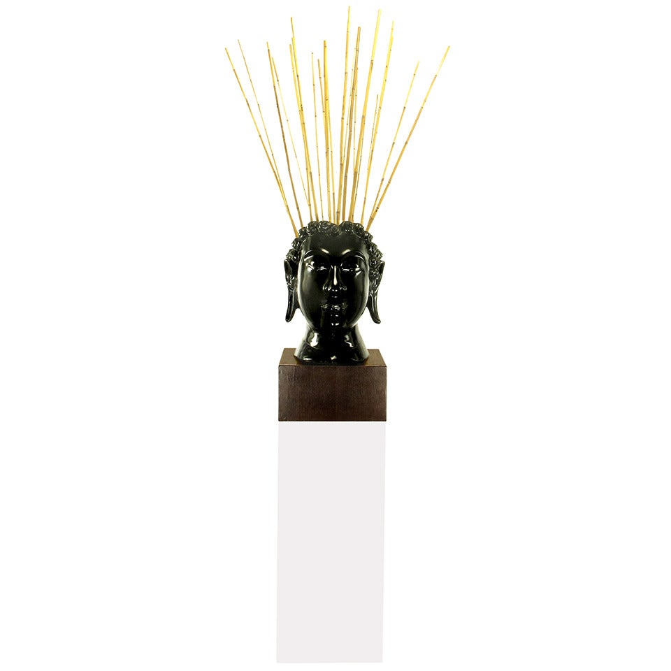 Carved and black lacquered mahogany bust of Buddha on mahogany plinth with white Lucite pedestal. The back of the head is open and can be used creatively. In this case, it is as a vessel for bamboo stalks.

Just the bust measures: 29