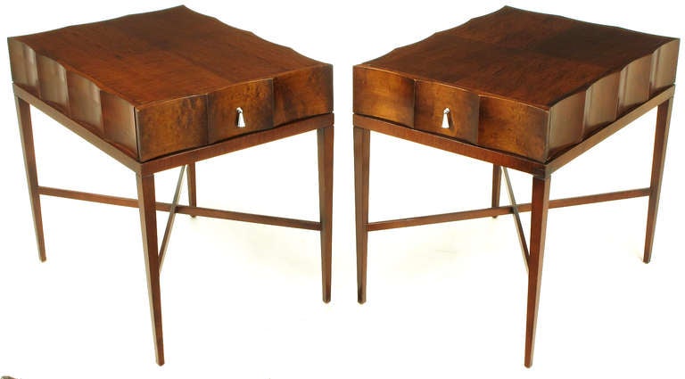 Art Deco inspired end tables by Baker Furniture. Constructed of ribbon mahogany veneers over wood, scalloped on all four sides and a parquetry top with excellent ribbon wood grain. Delicate legs joined by X stretcher.  Single tassel shaped nickel