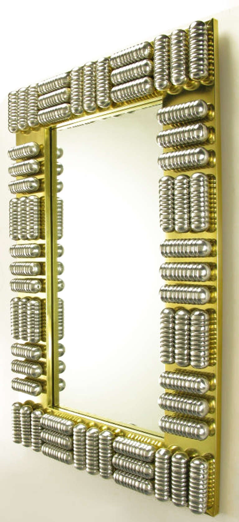 Custom-made wall mirror with brass wrapped wood frame and a series of polished and ribbed aluminum enclosed tubes. Each tube is wired to through the frame in two places. The mirrored glass is recessed into the frame three-quarters of an inch.