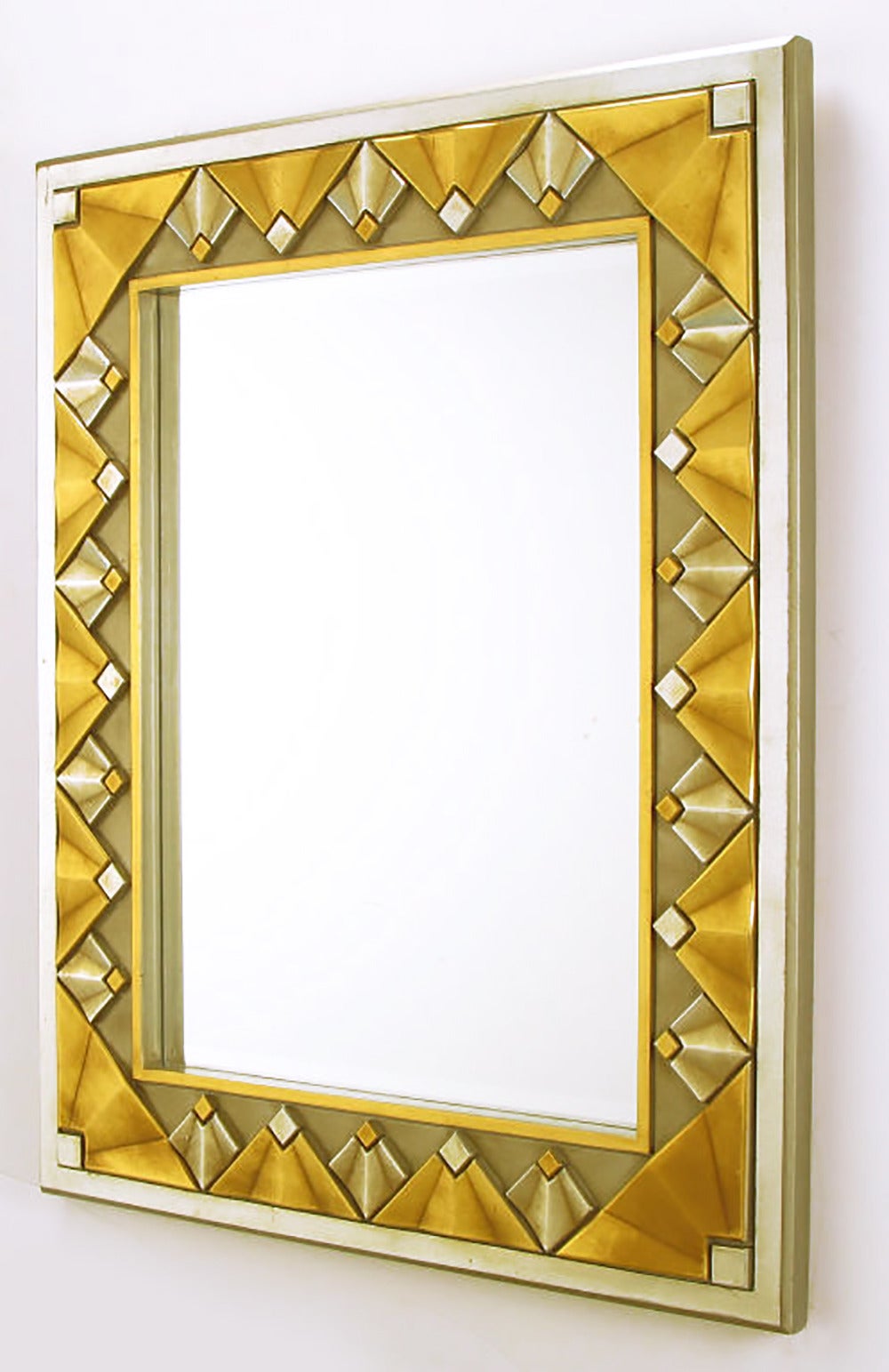 Well-made cast resin Art Deco revival wall mirror in gold and silver leaf with antiqued finish.