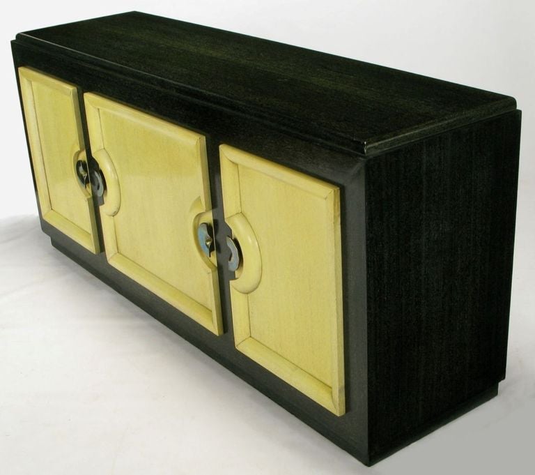 Black and ivory cerused lacquer finish and aged brass demilune pulls on this sleek sideboard by Stewartstown Furniture Company. The maker was a Pennsylvania furniture manufacturer located in Stewartstown, near the furniture making center around Red