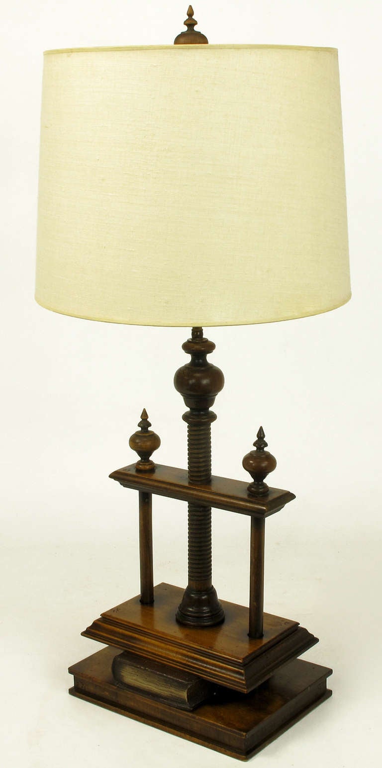 Fantastic table lamp in the form of a Victorian wood screw book press. Constructed of distressed walnut and fruit woods, brass stem and double socket cluster. Sold sans shade.